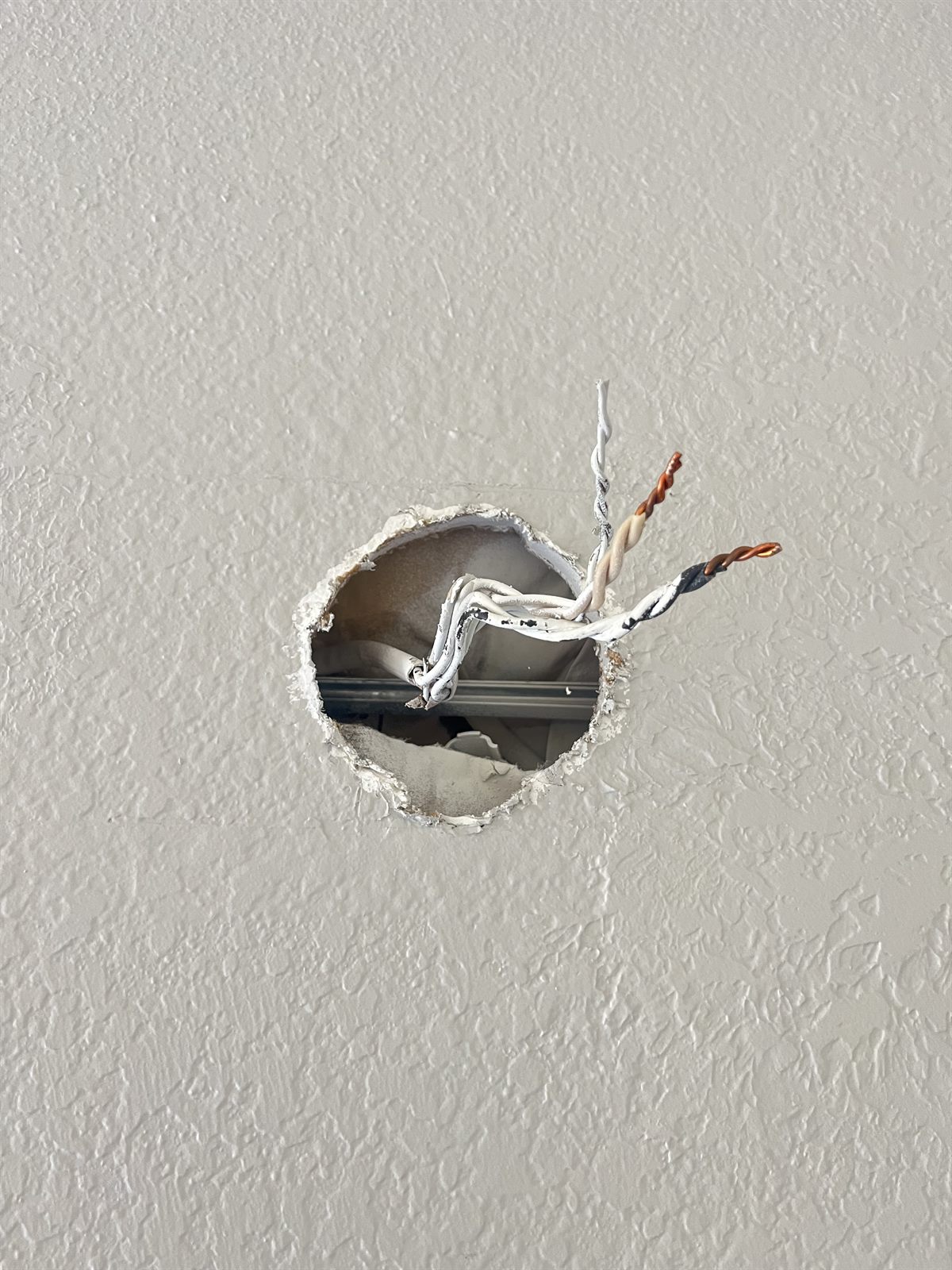 Supply wires poking out of the wall with no electrical box behind them