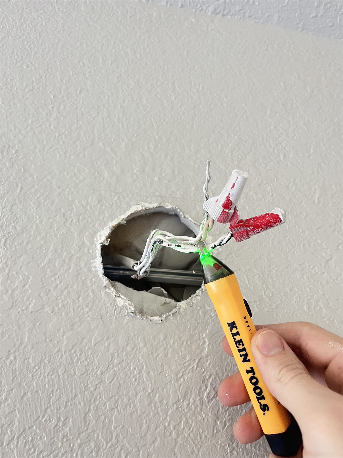 Checking the wires with a non-contact voltage tester