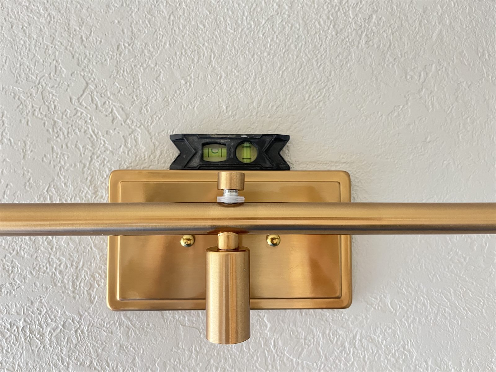 The fixture mounted and being leveled